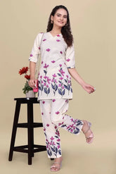 Woman wearing a floral outfit with a beige background