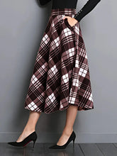 Plaid skirt worn by a person on a gray background