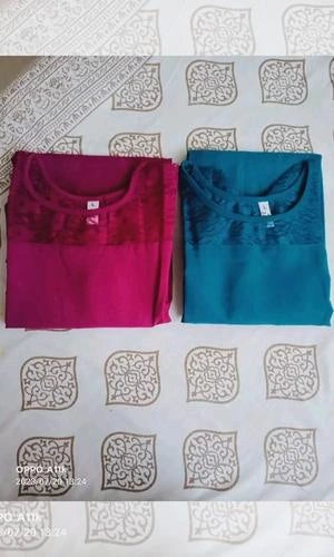 Two pieces of fabric, one red and one blue, on a patterned surface.