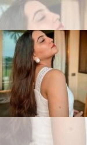 Woman with long hair and earrings in a casual setting