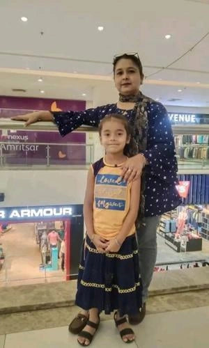 Woman and child posing together in a mall setting