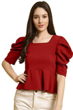 Woman wearing a red blouse with puffed sleeves on a white background