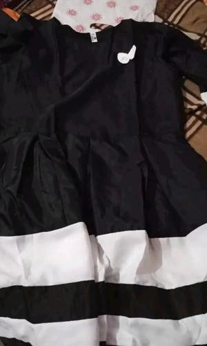 Black and white dress with a bow detail on a plain background