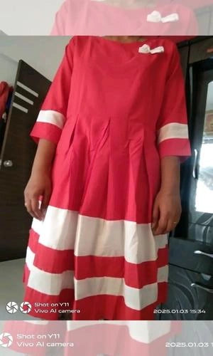 Red and white dress with a bow detail on a person, taken with a Vivo phone.