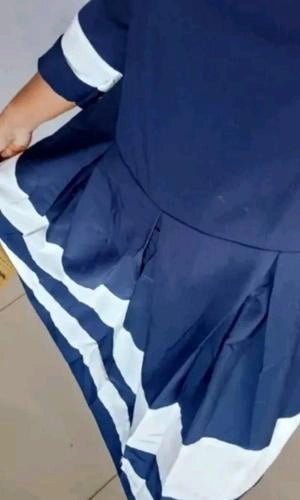 Navy blue dress with white trim on a table