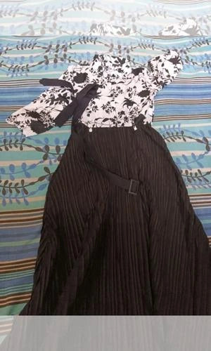 Black dress with a white patterned headscarf on a colorful abstract background