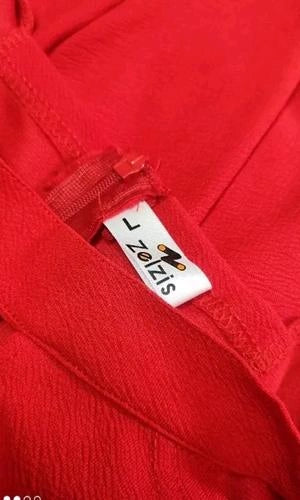 Red garment with a visible brand label on a blurred background