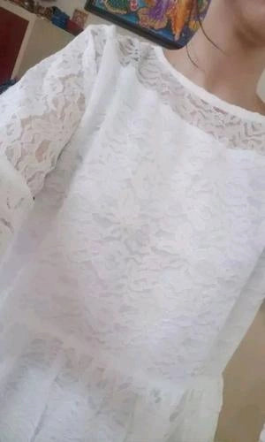 Close-up of a white lace garment with a blurred background