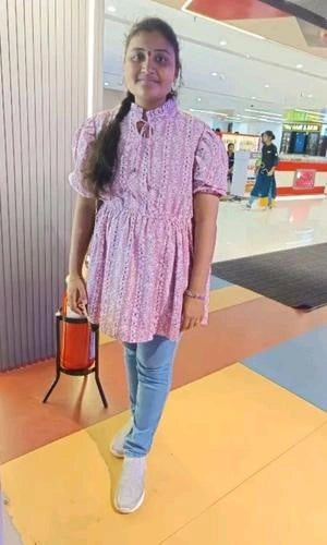 Woman in a pink dress standing in a mall