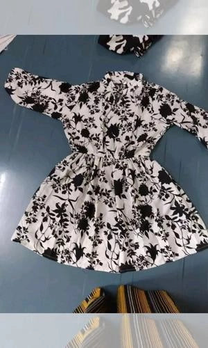 Black and white floral dress on a blue surface