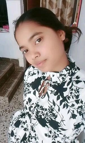 Person wearing a black and white floral dress indoors