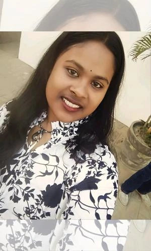 Woman wearing a black and white floral patterned outfit with a blurred background