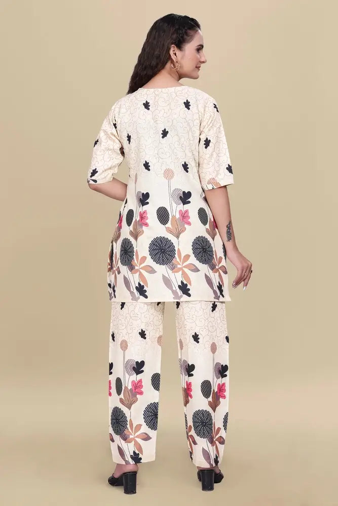 Woman wearing a floral kurta and palazzo set on a beige background