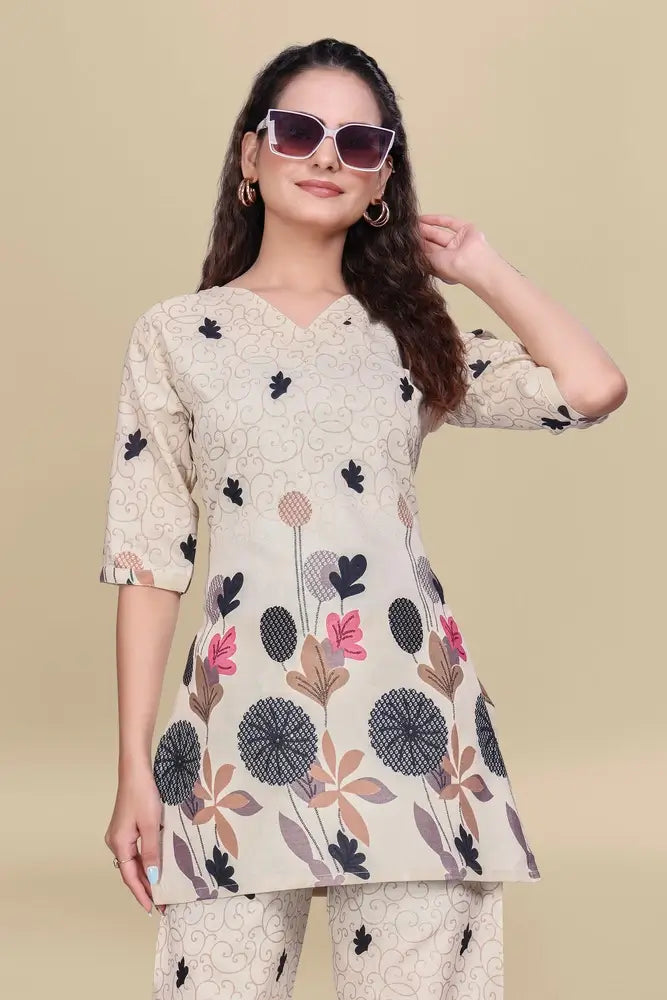 Woman wearing a floral printed kurta with sunglasses on a beige background
