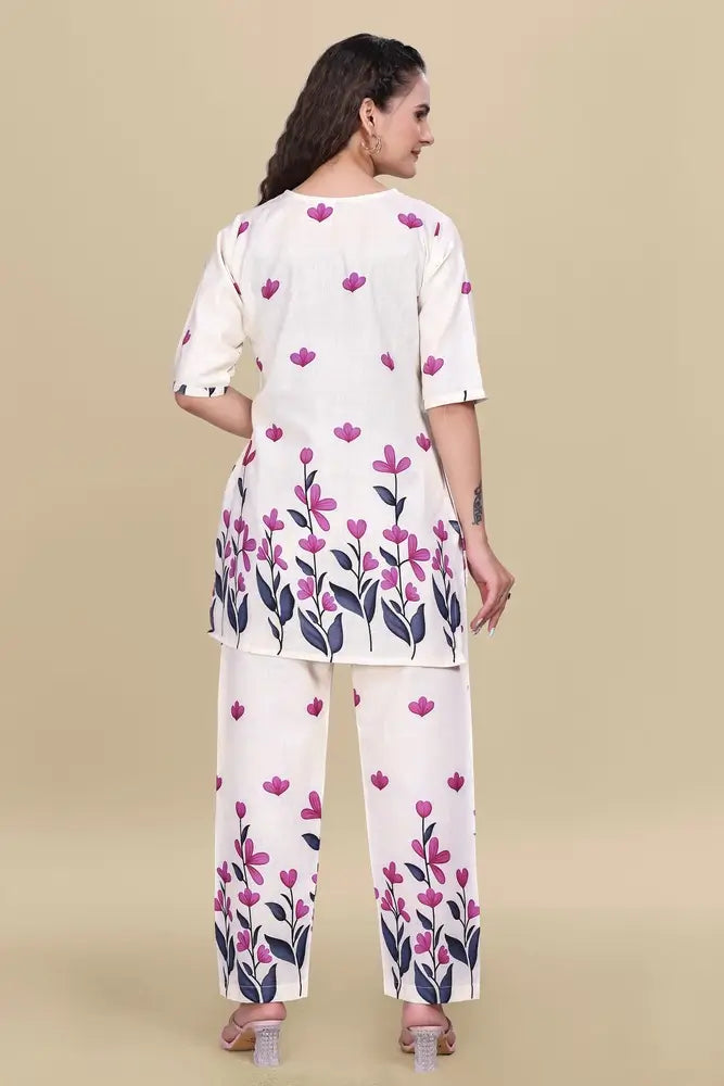 Woman wearing a white outfit with floral patterns on a beige background