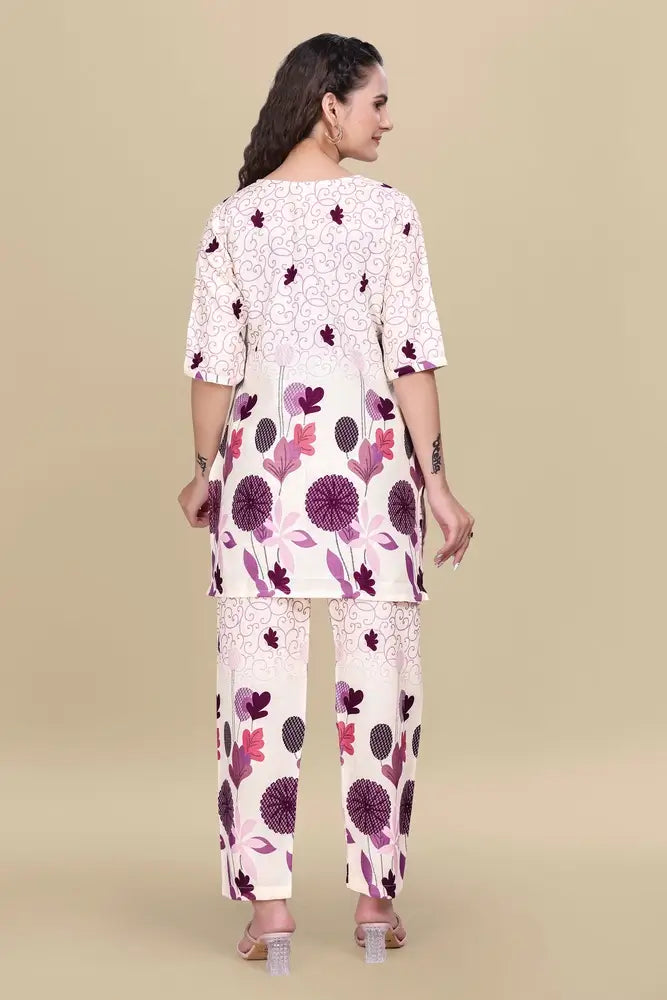 Woman wearing a floral kurta and pants set on a beige background