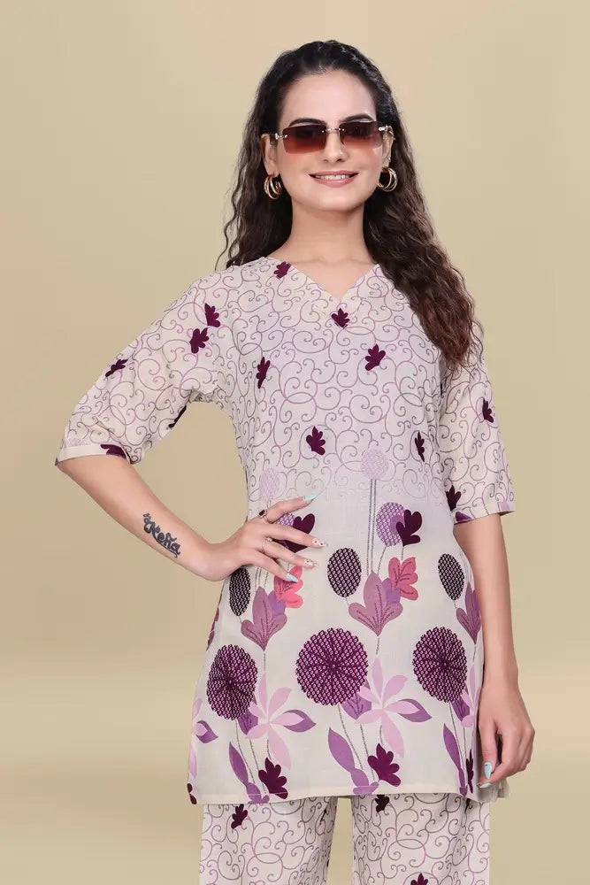 Woman wearing a floral printed kurta with a beige background