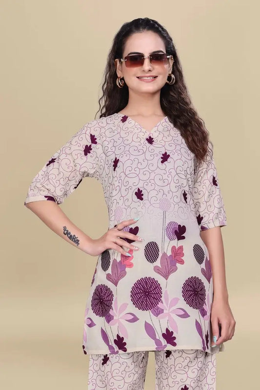 Woman wearing a floral printed kurta with a beige background