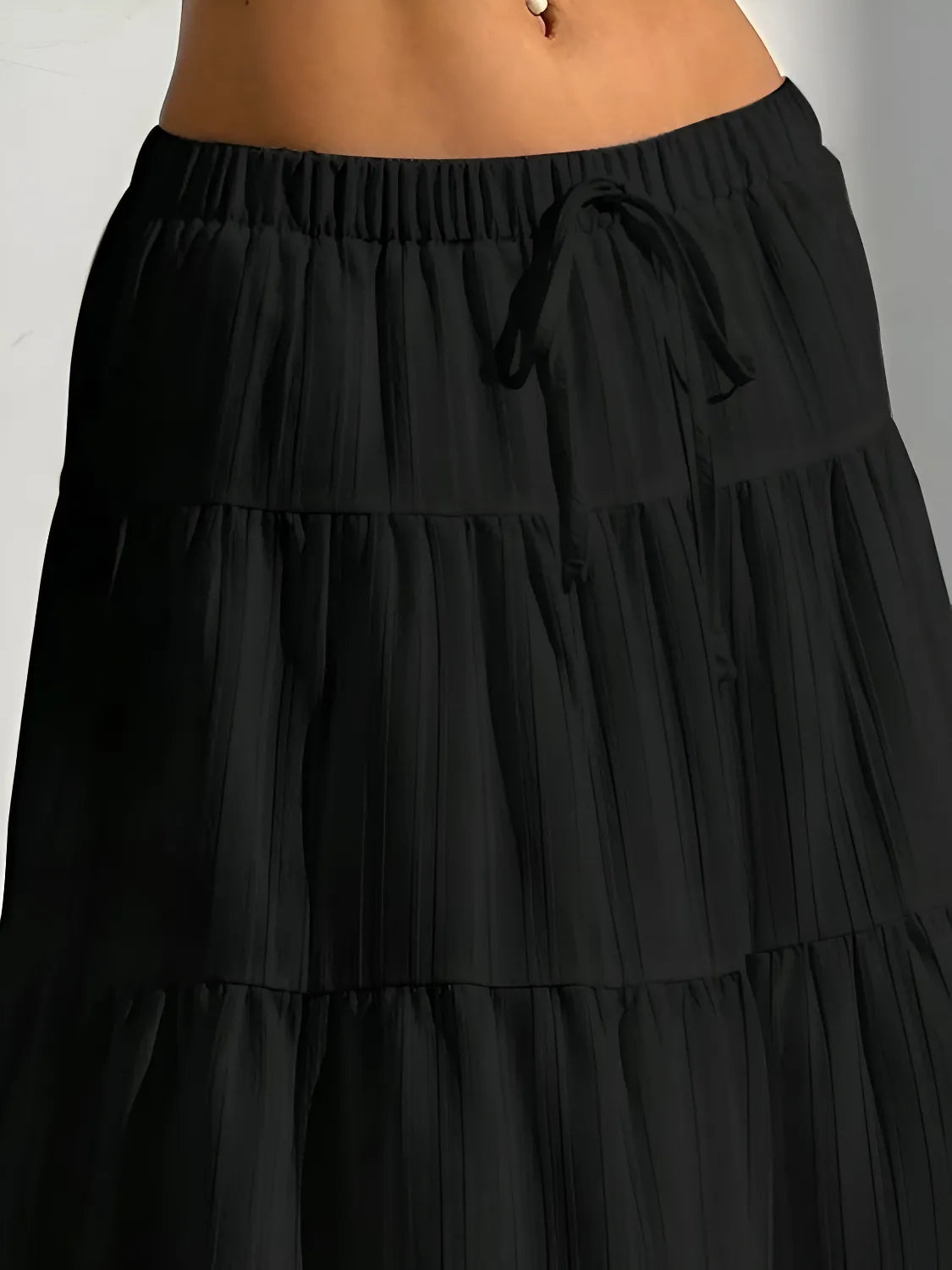 Black tiered skirt on a plain background