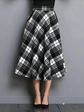 Black and white plaid skirt on a plain background