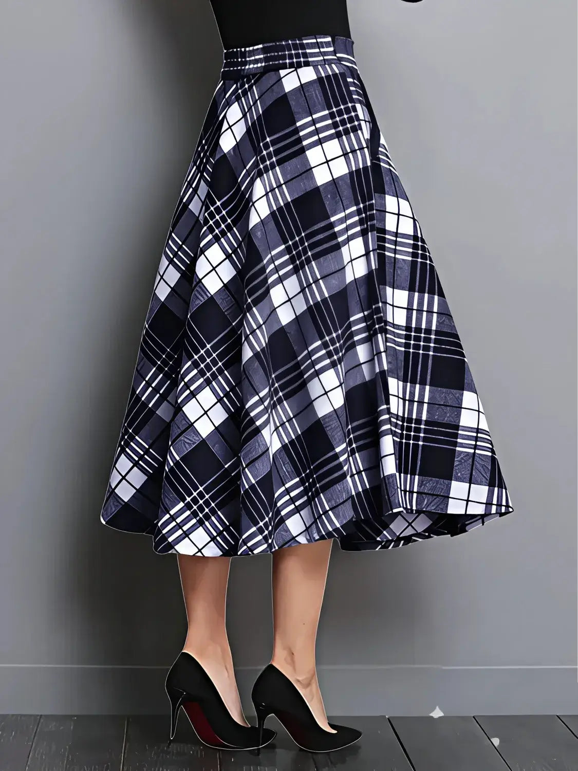 Plaid skirt with black high-heeled shoes on a gray background