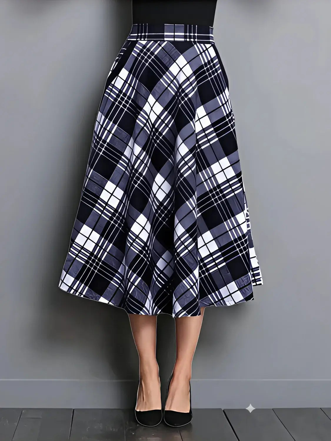 Plaid skirt worn by a person on a gray background