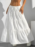 White tiered skirt worn by a person on a plain background