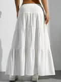 White tiered skirt worn by a person on a plain background