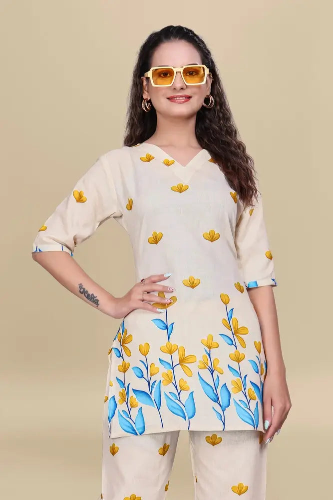 Woman wearing a cream-colored outfit with floral patterns on a beige background