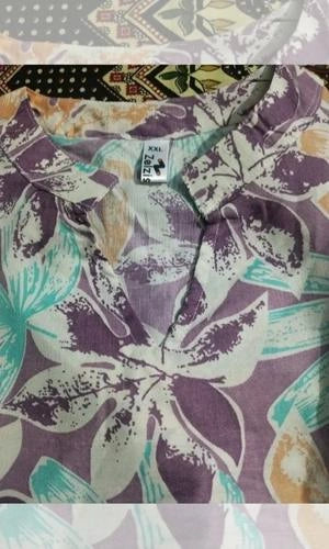 Close-up of a floral-patterned shirt with a brand label.