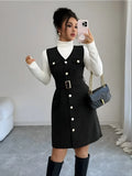 Woman taking a mirror selfie wearing a black button-up dress with a white turtleneck and knee-high boots.