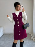 Woman taking a mirror selfie wearing a burgundy dress with white buttons, white turtleneck, black knee-high boots, and holding a black handbag.