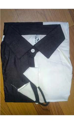 Black and white polo shirt on a wooden surface