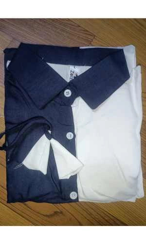 Folded shirt with collar and buttons on a wooden surface